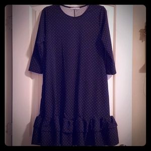 Black dress with white polka dots and side pockets